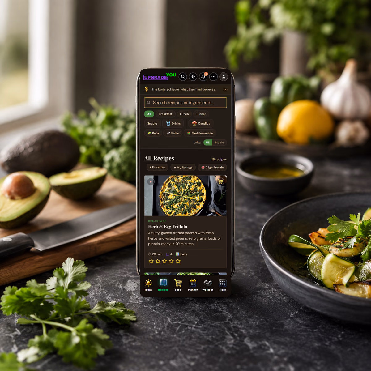 The Anti-Candida Kitchen app on a phone in a kitchen, showing its recipe library